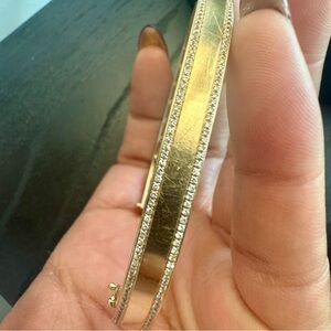 2 rows of glittering pavé diamonds line this iconic gold bangle (some scratches)